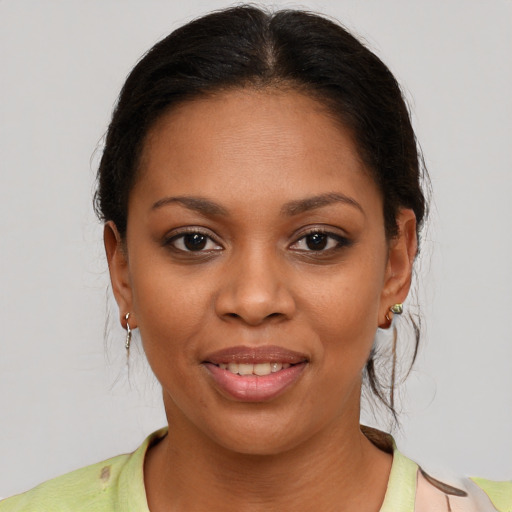 Joyful black young-adult female with medium  brown hair and brown eyes