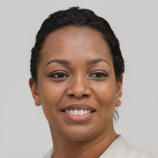 Joyful black young-adult female with short  black hair and brown eyes