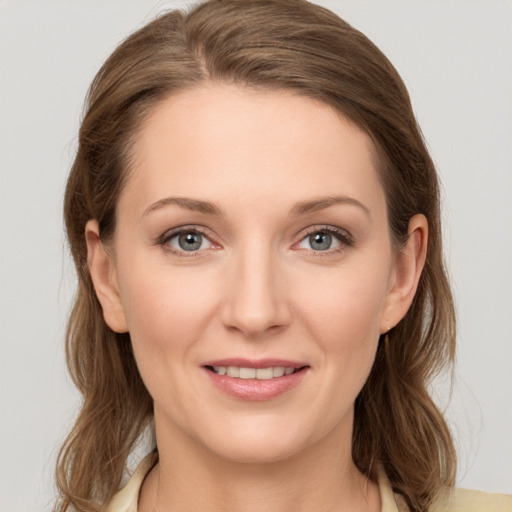 Joyful white young-adult female with medium  brown hair and grey eyes