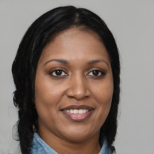 Joyful black young-adult female with medium  brown hair and brown eyes