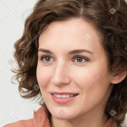 Joyful white young-adult female with medium  brown hair and green eyes