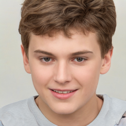 Joyful white child male with short  brown hair and brown eyes