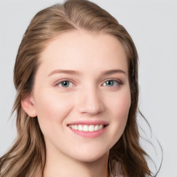 Joyful white young-adult female with long  brown hair and blue eyes