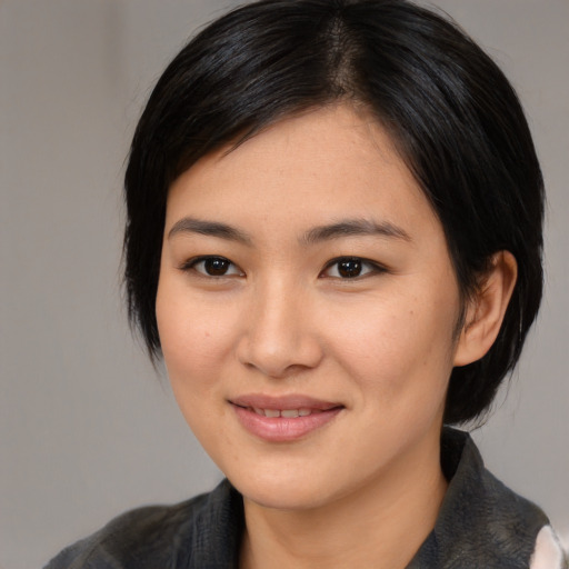 Joyful asian young-adult female with medium  black hair and brown eyes