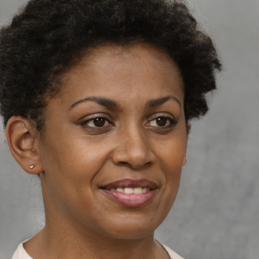 Joyful black young-adult female with short  brown hair and brown eyes