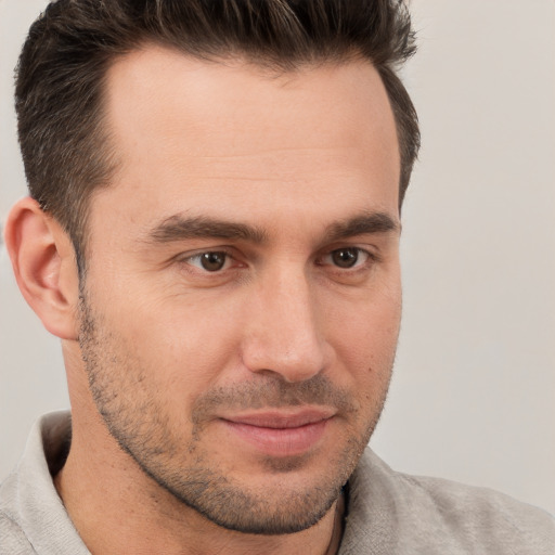 Joyful white adult male with short  brown hair and brown eyes