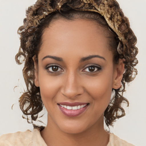 Joyful black young-adult female with long  brown hair and brown eyes