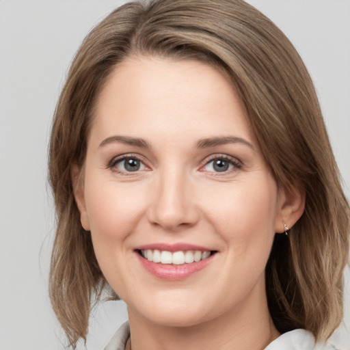 Joyful white young-adult female with medium  brown hair and green eyes