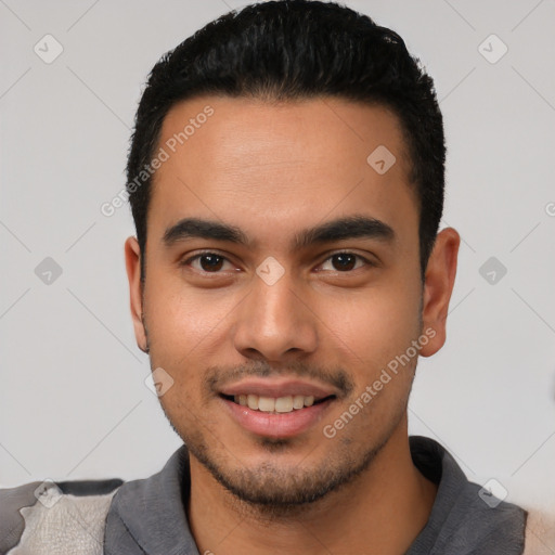 Joyful latino young-adult male with short  black hair and brown eyes