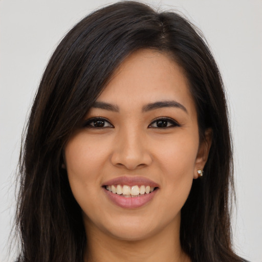 Joyful asian young-adult female with long  brown hair and brown eyes