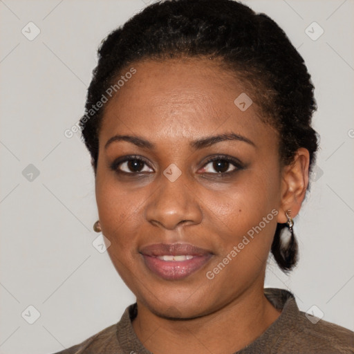 Joyful black young-adult female with short  black hair and brown eyes