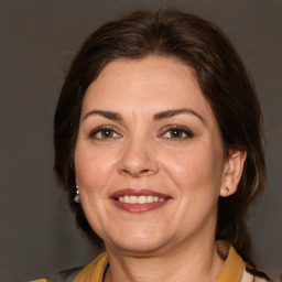 Joyful white adult female with medium  brown hair and brown eyes