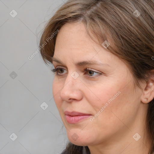 Joyful white adult female with medium  brown hair and grey eyes