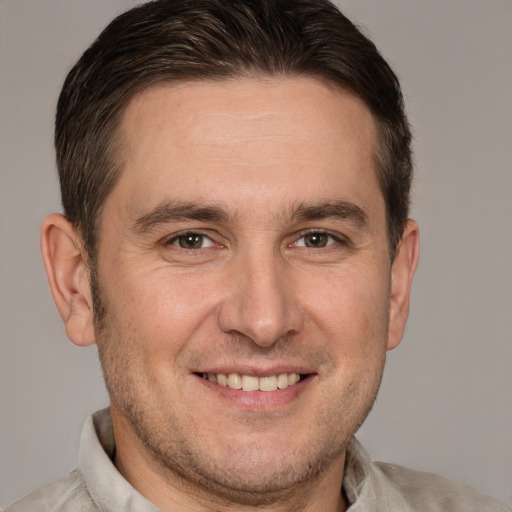 Joyful white adult male with short  brown hair and brown eyes