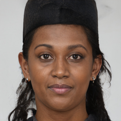 Joyful black young-adult female with long  black hair and brown eyes