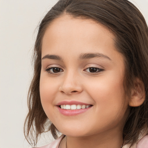 Joyful white child female with long  brown hair and brown eyes