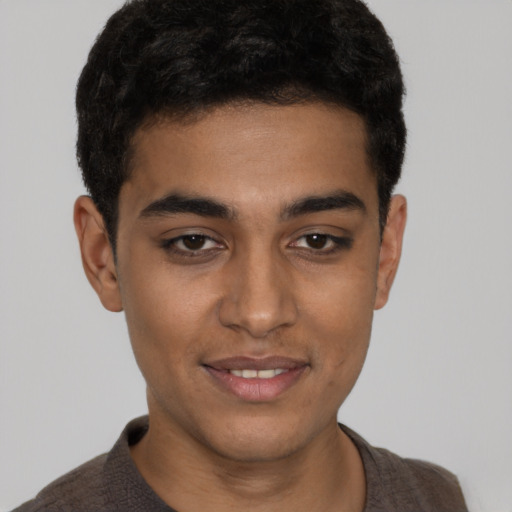 Joyful latino young-adult male with short  brown hair and brown eyes