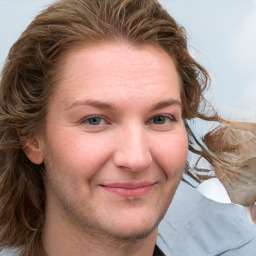 Joyful white young-adult female with long  brown hair and blue eyes