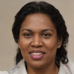 Joyful black adult female with medium  brown hair and brown eyes