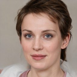 Joyful white young-adult female with medium  brown hair and blue eyes