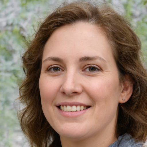 Joyful white young-adult female with medium  brown hair and green eyes