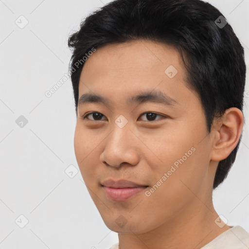 Joyful asian young-adult male with short  black hair and brown eyes