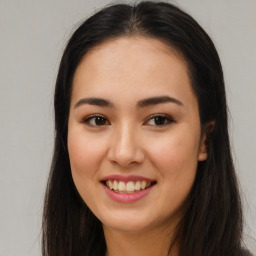 Joyful latino young-adult female with long  brown hair and brown eyes