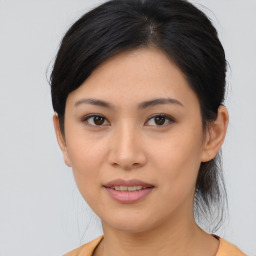 Joyful asian young-adult female with medium  brown hair and brown eyes