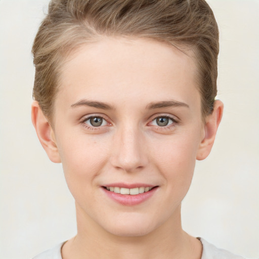 Joyful white young-adult female with short  brown hair and grey eyes