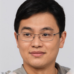 Joyful asian adult male with short  brown hair and brown eyes