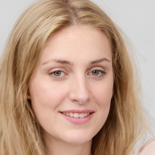 Joyful white young-adult female with long  brown hair and green eyes