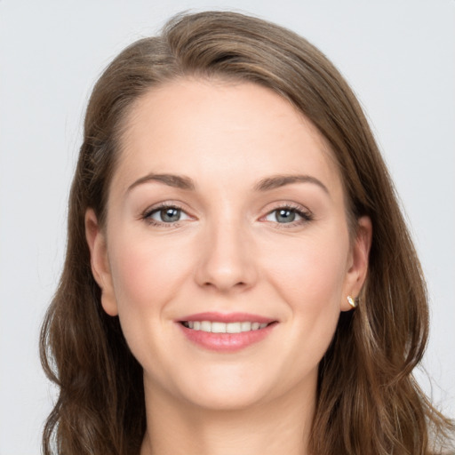 Joyful white young-adult female with long  brown hair and grey eyes