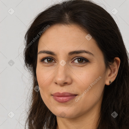 Joyful white adult female with long  brown hair and brown eyes