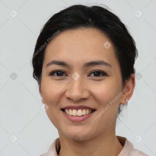 Joyful asian young-adult female with medium  brown hair and brown eyes