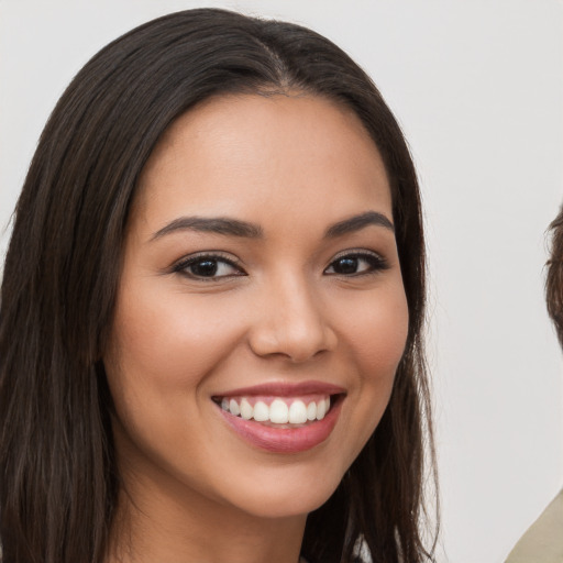 Joyful white young-adult female with long  brown hair and brown eyes