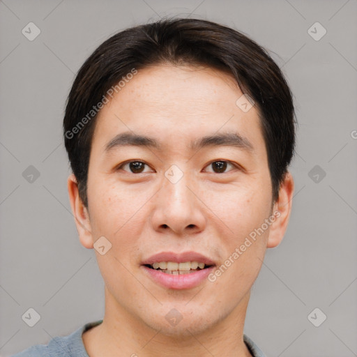 Joyful asian young-adult male with short  brown hair and brown eyes