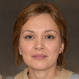 Joyful white adult female with medium  brown hair and brown eyes