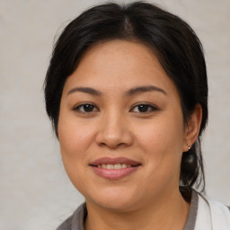 Joyful asian young-adult female with medium  brown hair and brown eyes