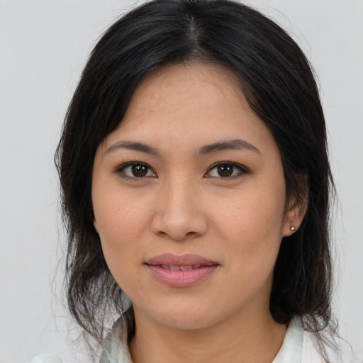 Joyful asian young-adult female with medium  brown hair and brown eyes