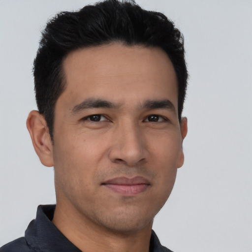 Joyful asian young-adult male with short  black hair and brown eyes