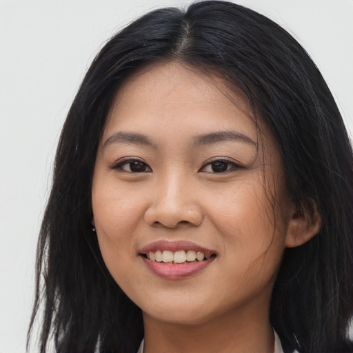 Joyful asian young-adult female with long  brown hair and brown eyes