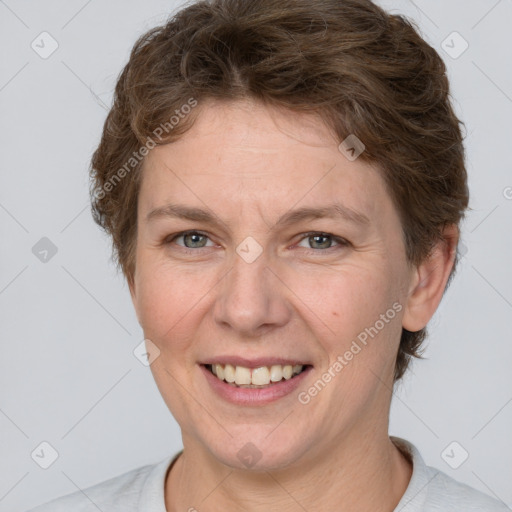 Joyful white adult female with short  brown hair and grey eyes