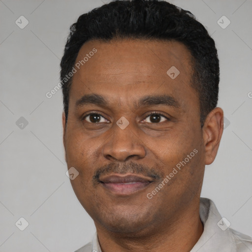 Joyful black young-adult male with short  black hair and brown eyes