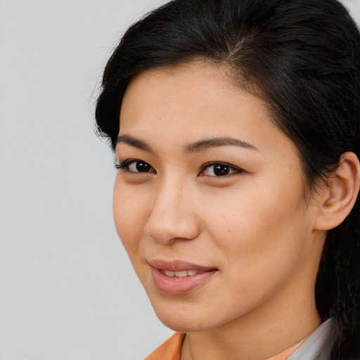 Joyful latino young-adult female with long  brown hair and brown eyes