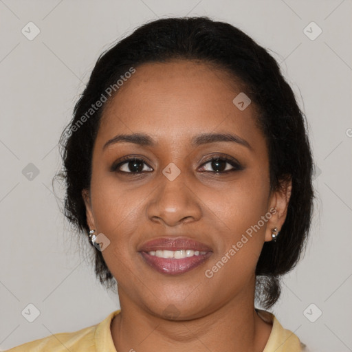 Joyful black young-adult female with long  black hair and brown eyes