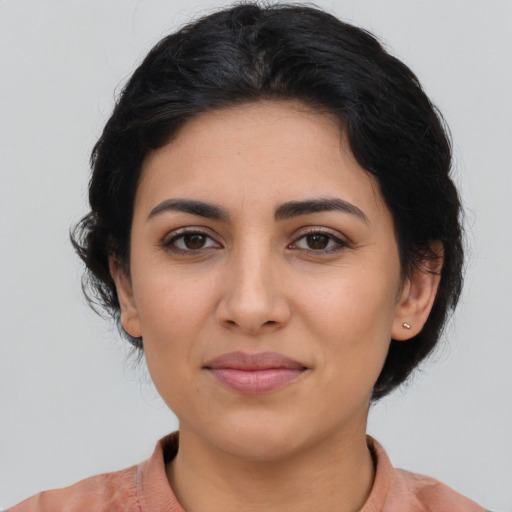 Joyful latino young-adult female with medium  brown hair and brown eyes