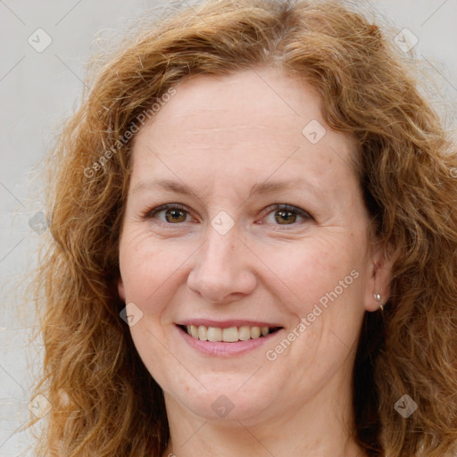 Joyful white adult female with long  brown hair and brown eyes