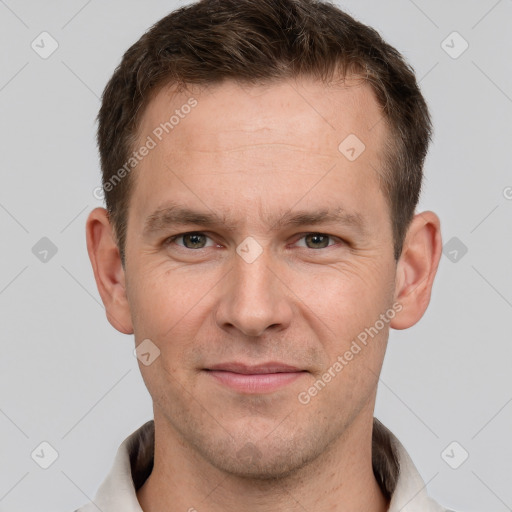 Joyful white adult male with short  brown hair and grey eyes