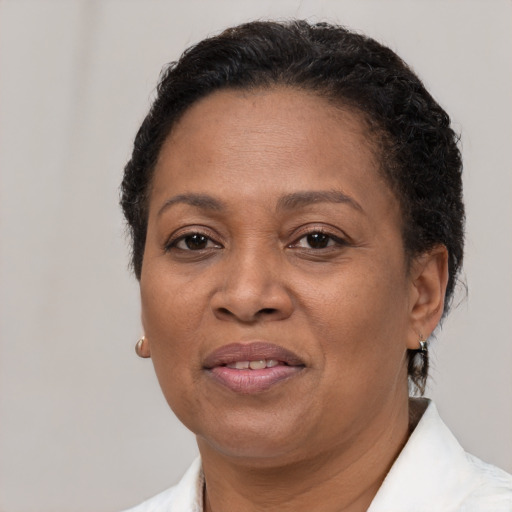 Joyful latino adult female with short  brown hair and brown eyes