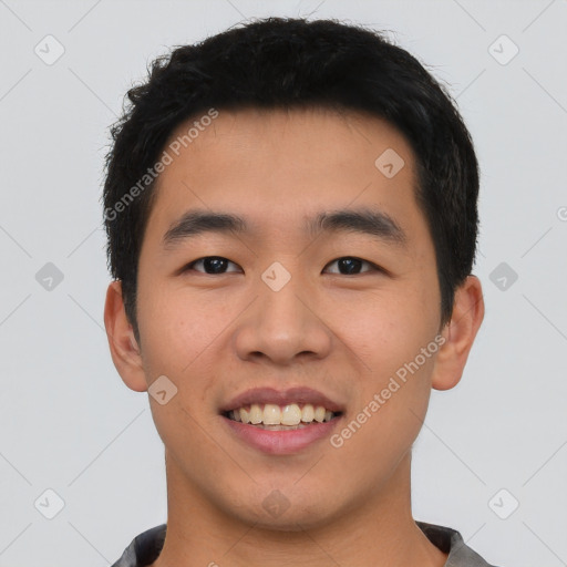 Joyful asian young-adult male with short  black hair and brown eyes